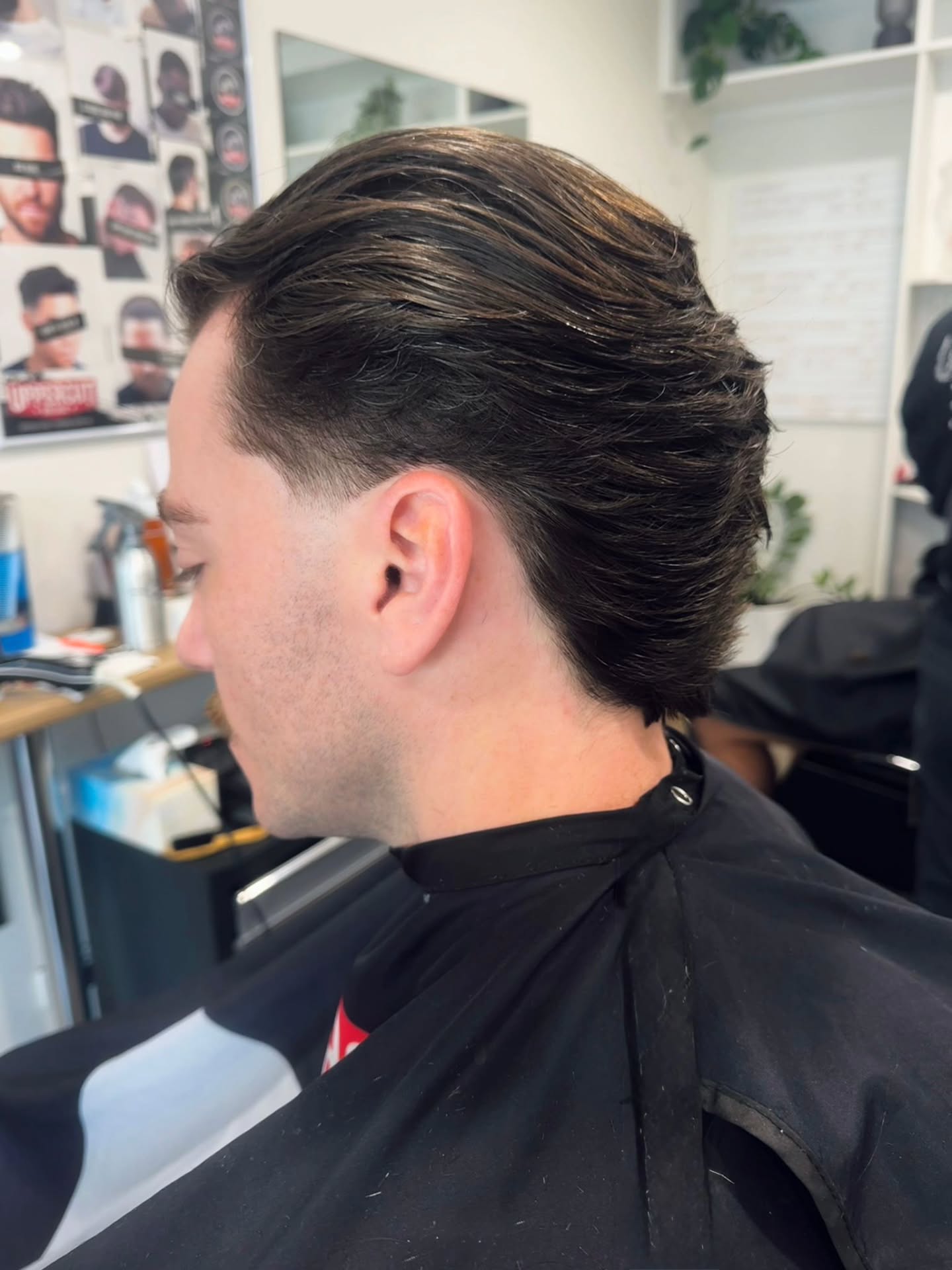 Slicked back cut with a fade, side view
