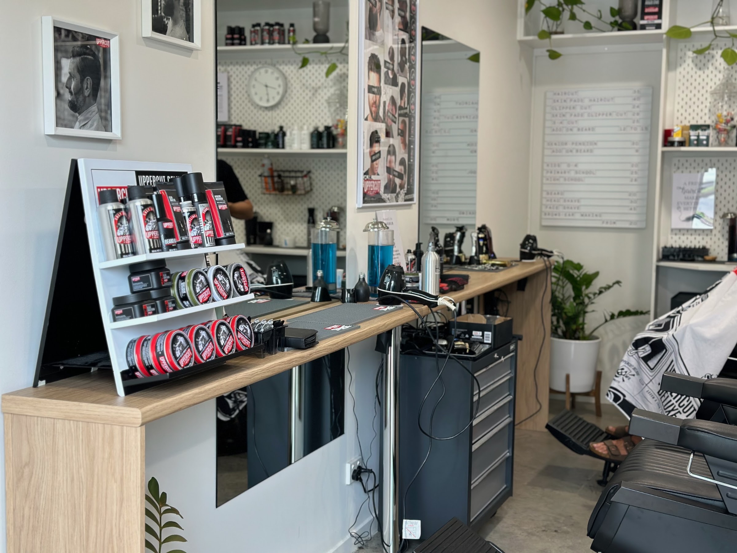 Inside the shop: timber bench, mirrors and the price board on the wall