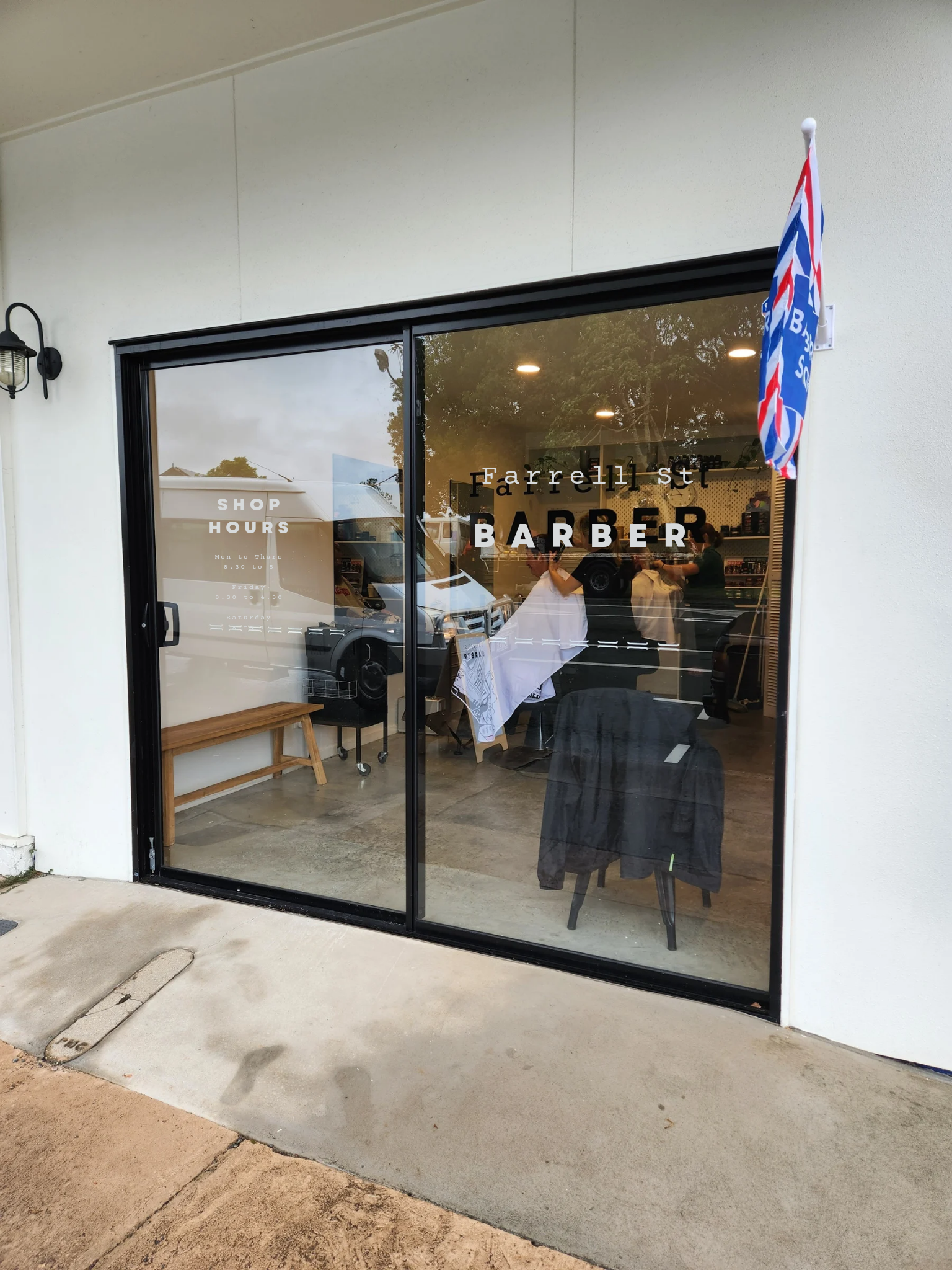 The shop door with the opening hours printed on the glass